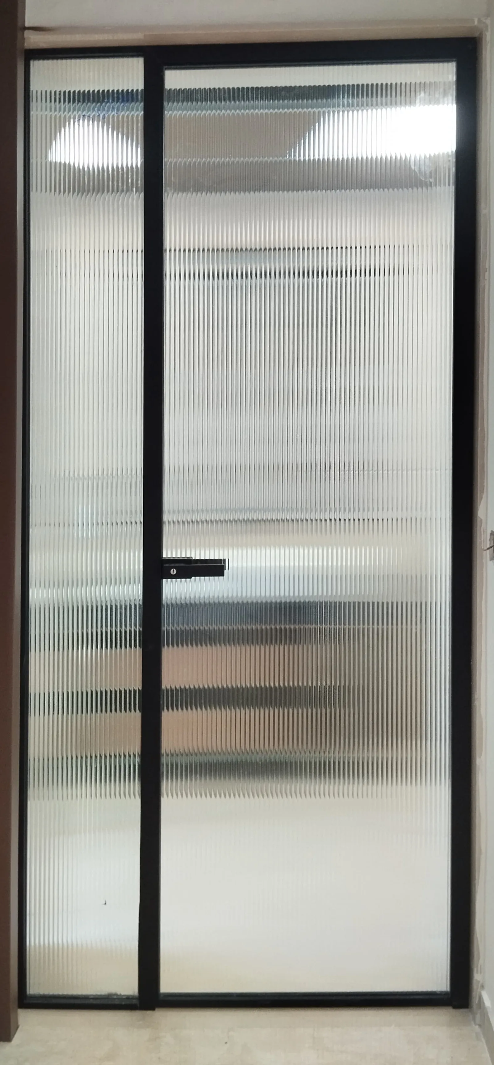 Matte black door and panel, fluted glass